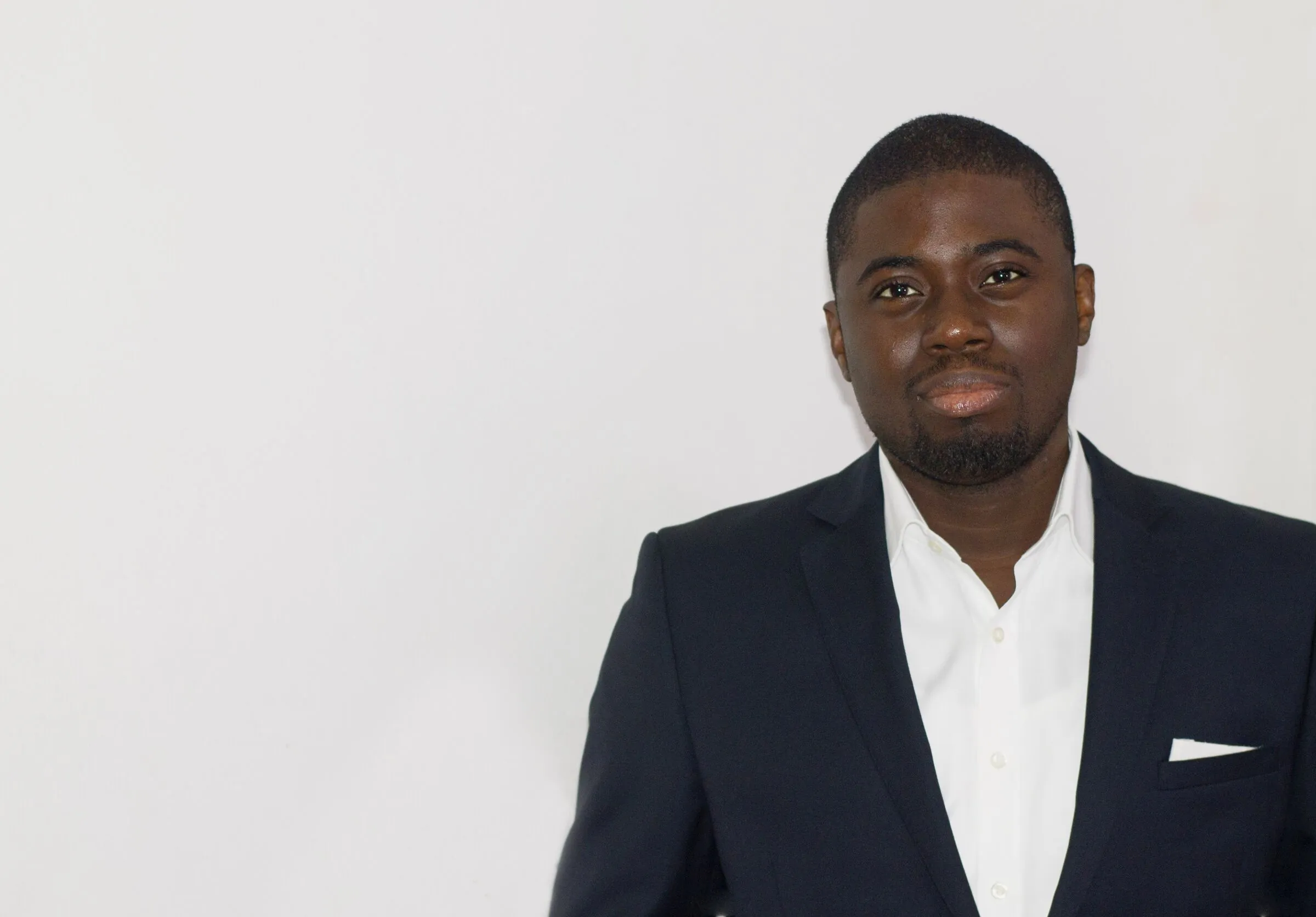 Chi Odogwu in a navy blazer against a pale wall